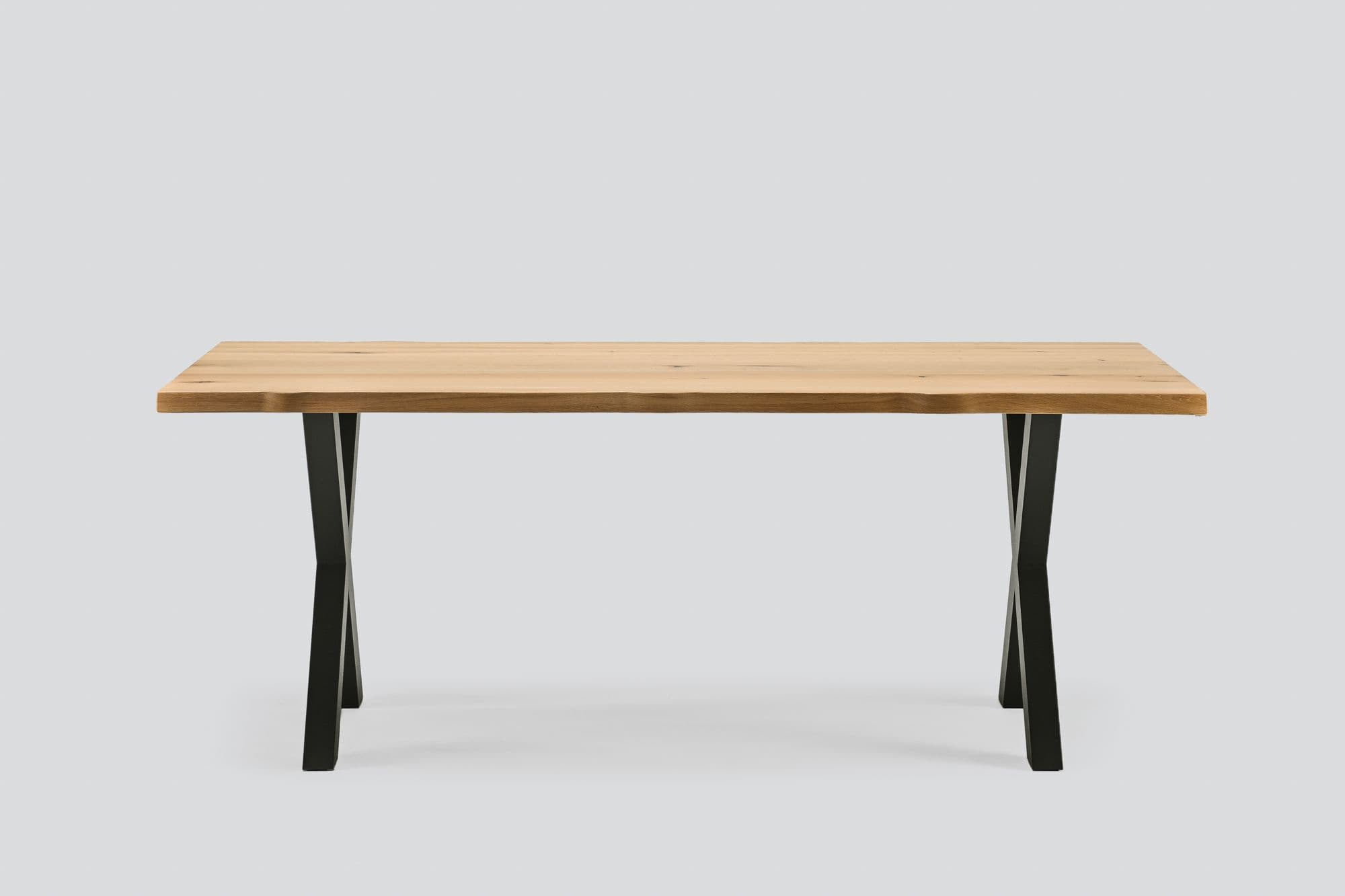 Nodus live-edge oak dining table with X-shaped metal legs