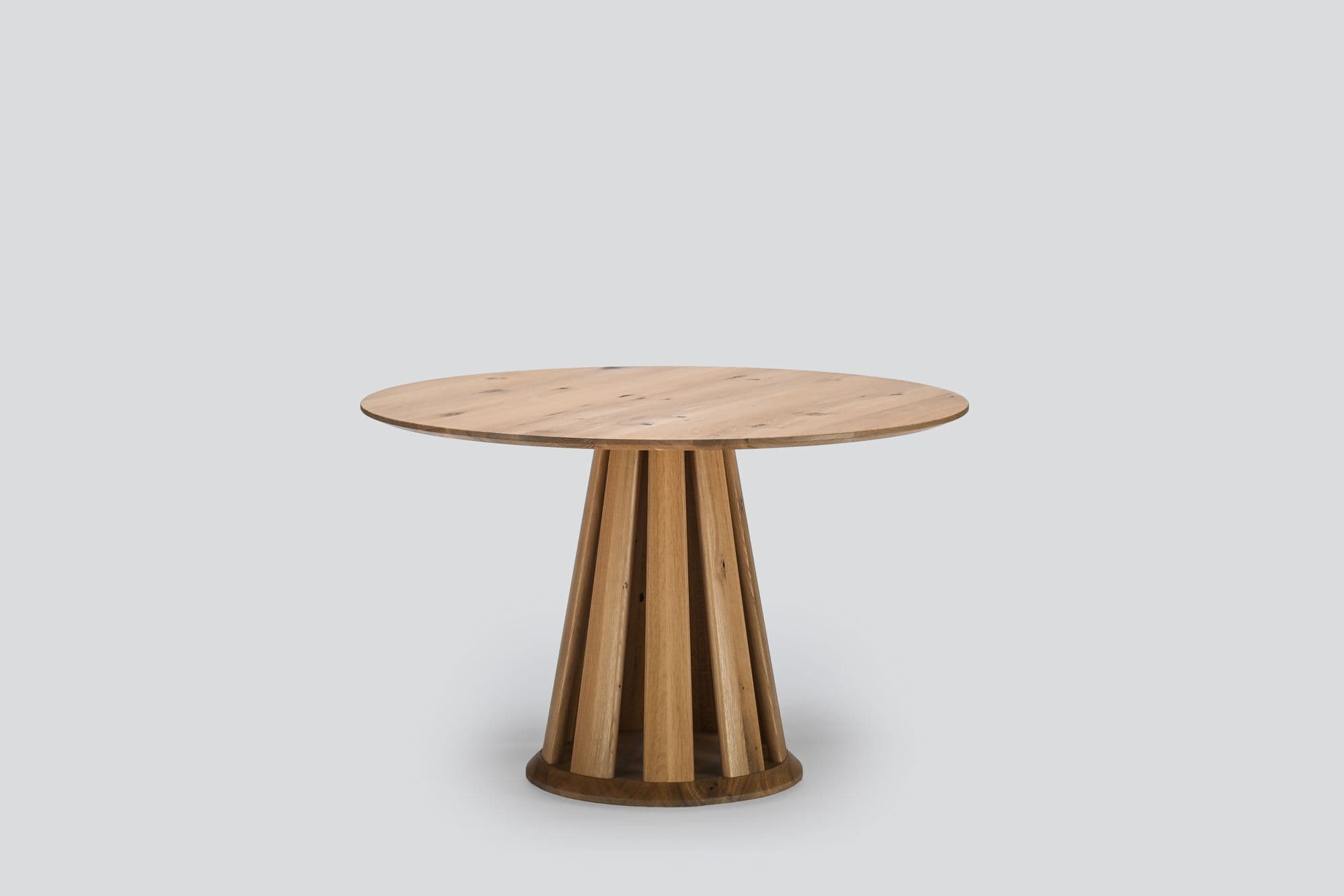 Orda round oak dining table with vertical wooden slat pedestal